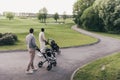 Two men carrying golf clubs in golf bags and walking at golf course Royalty Free Stock Photo