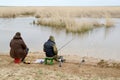 Two men catch fish rods in the river Manych. Kalmykia