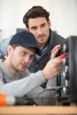 two men checking broken oven Royalty Free Stock Photo