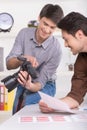 Two men are choosing a photo from a shoot. Royalty Free Stock Photo