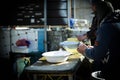 Two men cleaning fresh fish at the market