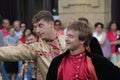 two men in costume dancing around in a crowd of people