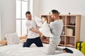 Two men couple fighting with pillows at bedroom Royalty Free Stock Photo