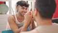 Two men couple sitting on table with hands together at dinning room Royalty Free Stock Photo