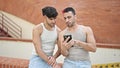 Two men couple using smartphone at street Royalty Free Stock Photo