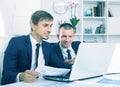 Two men coworkers working on computers in firm office Royalty Free Stock Photo