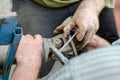 Two men disassemble the spindle of the propeller shaft of the car. Royalty Free Stock Photo