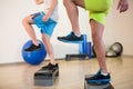 Two men doing step aerobic exercise on stepper Royalty Free Stock Photo