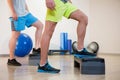 Two men doing step aerobic exercise on stepper Royalty Free Stock Photo