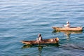 Two men in dugout canoes on Lake Atitlan, Guatemala Royalty Free Stock Photo