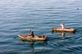 Two men in dugout canoes on Lake Atitlan, Guatemala Royalty Free Stock Photo