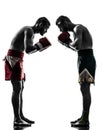 Two men exercising thai boxing salute silhouette Royalty Free Stock Photo