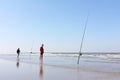 Two men fishing on the seashore