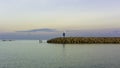 Two men fishing in the sea near lighthouse