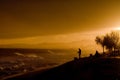 two men fishing on the shore in the evening sun during the day Royalty Free Stock Photo