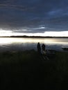 Two men fishing on a lake at twlight