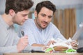 two men following instructions to assemble drone Royalty Free Stock Photo