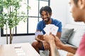 Two men friends playing poker cards sitting on sofa at home Royalty Free Stock Photo