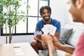 Two men friends playing poker cards sitting on sofa at home Royalty Free Stock Photo