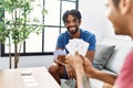 Two men friends playing poker cards sitting on sofa at home Royalty Free Stock Photo