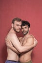 Two men, gay couple, shirtless posing in a studio, photo-shoot