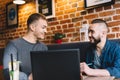 Two men in a good mood sitting by the laptop Royalty Free Stock Photo