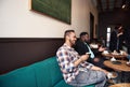 Two men hanging out with friends in a trendy cafe Royalty Free Stock Photo