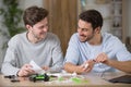 two men having fun assembling drone Royalty Free Stock Photo