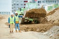 Building inspectors watching excavation process Royalty Free Stock Photo