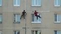 Two men are high-altitude assemblers for repair work. Industrial climbers work at height.