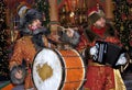 Two men in historical costumes play musical instruments