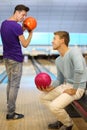 Two men hold balls in bowling club Royalty Free Stock Photo