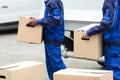 Two Men Holding The Cardboard Boxes Royalty Free Stock Photo