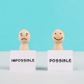 Two men holding signs, possible and impossible concept, mindset of an optimist and a pessimist, change the attitude for progress Royalty Free Stock Photo