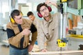 two men holding timber on woodworking machine Royalty Free Stock Photo