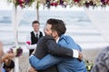 Two men hugging at wedding ceremony Royalty Free Stock Photo