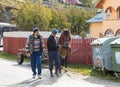 Two men lead by the bridle of a horse harnessed to a wagon in a suburb of Bran city in Romania Royalty Free Stock Photo