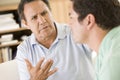 Two men in living room talking Royalty Free Stock Photo