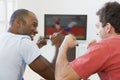 Two men in living room watching television