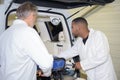 Two men loading stretcher into ambulance Royalty Free Stock Photo