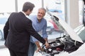 Two men looking at a car engine Royalty Free Stock Photo