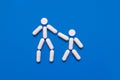 The shape of two little men from tablets on a blue background, the concept of treatment and protection against disease Royalty Free Stock Photo