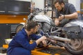 Two men in a motorcycle workshop. Royalty Free Stock Photo