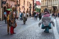 Two men, one with a shark costume, the other with an idian outfit, advertising for shops in the medieval old town of Prague Royalty Free Stock Photo