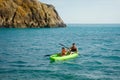 Two men paddle a kayak on the sea. Kayaking on island Royalty Free Stock Photo