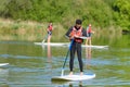 two men on paddle surfboards