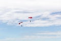 Two men parachuting high in the sky.