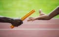 Two men passing golden baton in stadium. Conceptual image shot