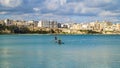 Two men on pedal surfboards in the shallow waters off Lungomare degli Eroi promenade