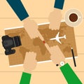 Two men planning vacation trip with map. Camera, airplane model, cup of coffee, pen on table